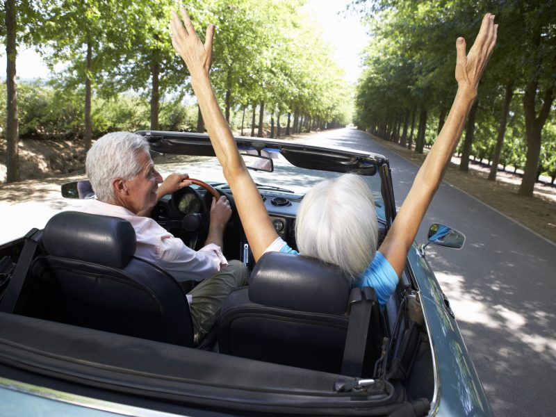 Senior couple in sports car