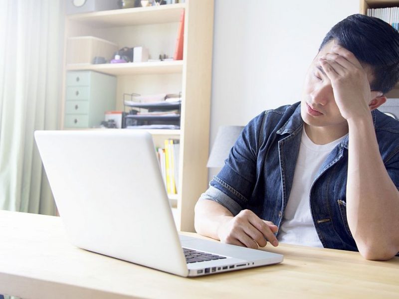 man looking at computer trying to financially recovering from covid19